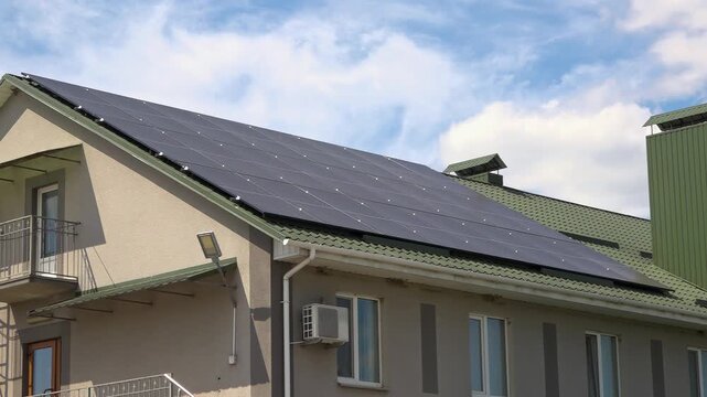 Solar panels installed on the roof of a city building. Concept of eco friendly and alternative power source. 