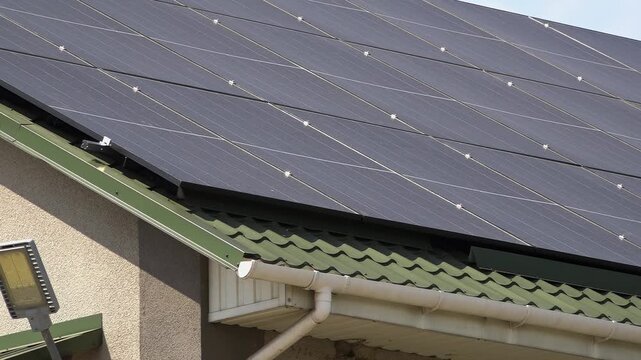 Solar panels installed on the roof of a city building. Concept of eco friendly and alternative power source. 