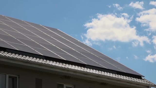 Solar panels installed on the roof of a city building. Concept of eco friendly and alternative power source. 