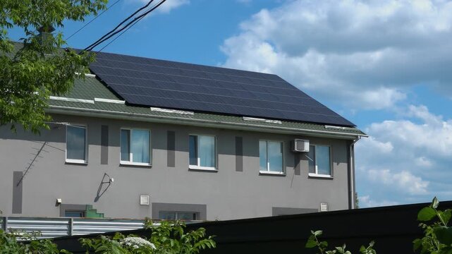 Solar panels installed on the roof of a city building. Concept of eco friendly and alternative power source. 