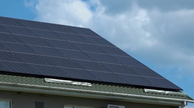 Solar panels installed on the roof of a city building. Concept of eco friendly and alternative power source. 