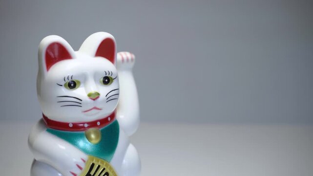 Chinese lucky cat Maneki Neko waving paw decorative figurine close up