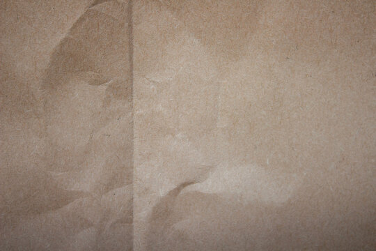 Brown crumpled paper texture background for recycling and craft projects, featuring an aged, natural surface pattern