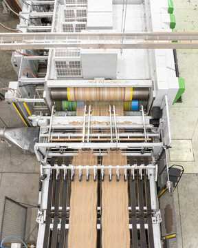 Aerial view of a large industrial cardboard manufacturing machine with rollers and conveyor belts in a factory in Mexico City, Mexico City, Mexico.