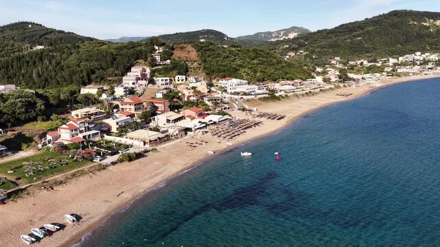 Aerial view of Pelekas beach with blue water and houses in Corfu Greece during day