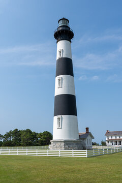 Bodie Island Lighthouse stands against clear blue sky of Cape Hatteras National Seashore