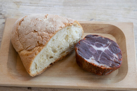 rustic bread cured meat capocollo wooden board