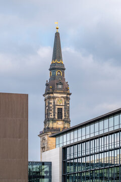 Church tower rising above modern architecture in Copenhagen Denmark with historic landmark character framed by a contemporary glass building