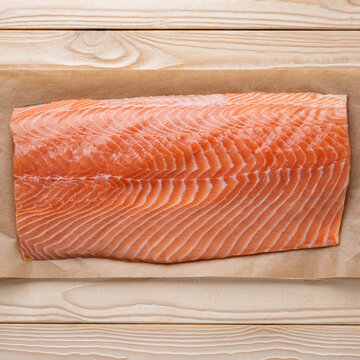 Raw salmon fillet square minimal food background top view