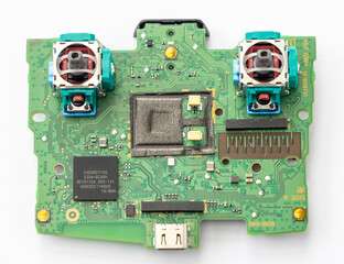Green Game Controller Circuit Board with Joysticks and Various Components © YouraPechkin