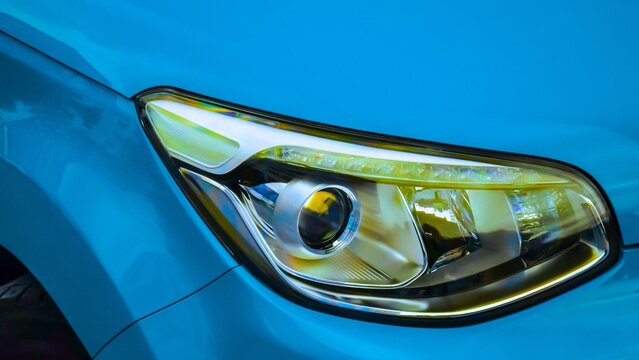 Modern car headlight design with blue bodywork for vehicle engineering