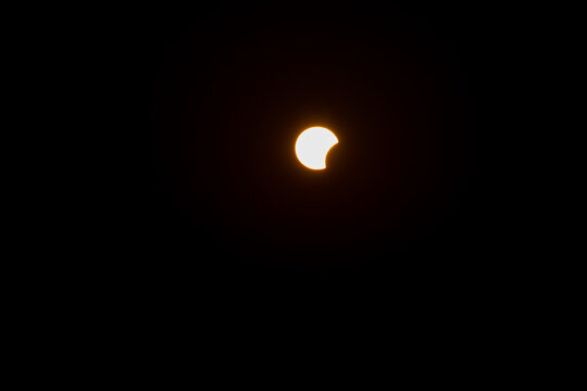 Beginning of solar eclipse seen from Croatian coast, on august, 12th, 2026, during the sunset when sun was setting together with a moon, bright sun against dark sky