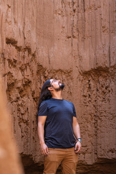 Man with Long Hair Looking Up Inside Clay Canyon or Mine. Tatacoita - Nemocon