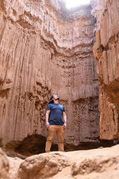 Man Looking Up inside Clay Canyon with Bright Sunlight Above. Tatacoita - Nemocon