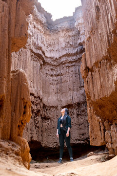 Woman exploring towering rock formations in a rugged canyon. Tatacoita - Nemocon