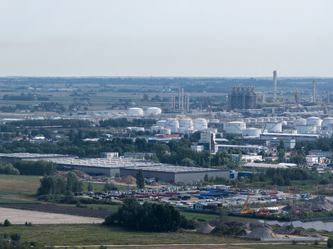 Aerial view of the PKN Orlen industrial complex featuring storage tanks, processing facilities, and surrounding green landscape in Plock, Masovian Voivodeship, Poland.