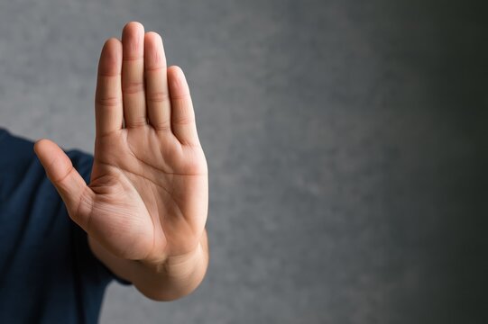 Hand stop gesture with open palm signal for refusal denial warning and caution
