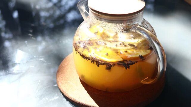 A classic glass pitcher filled with lemonade sits on a wooden tabletop, ready for refreshment