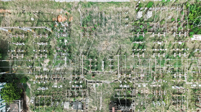 Aerial view of the electrical substation in Tharamani with various transformers, power lines, and electrical equipment set against a grassy landscape in Chennai, Tamil Nadu, India.