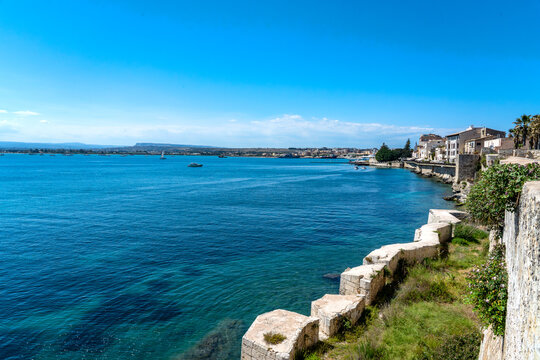 a panoramic view of the Syracuse coastline with its intensely blue sea and sky