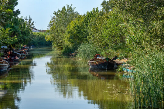 Traditional colourful boats from La Albufera Natural Park, in Valencia, Spain, moored in the harbour