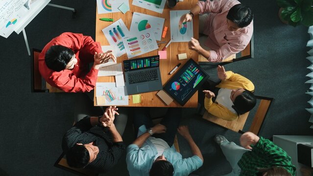 Top down view of business team putting hand together while discussing about Ux Ui design for mobile phone at boardroom. Close up of marketing team making stack of hand and clapping hand. Convocation.