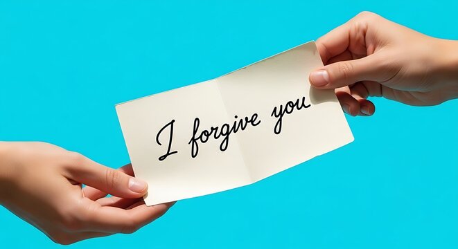 hands holding a handwritten forgiveness message card