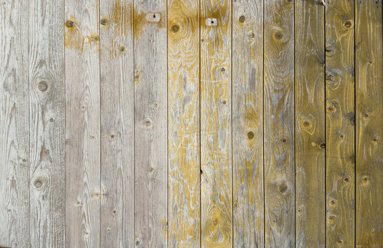 Rustic weathered vertical timber planks background with faded white and ochre painted finish