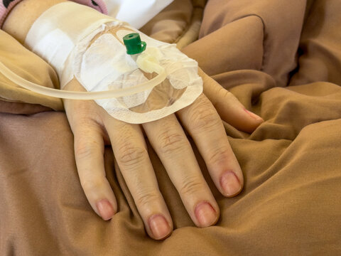 Closeup of patient hand with intravenous cannula during hospital treatment closeup