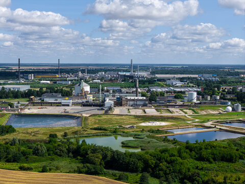 Aerial view of the industrial complex and factory facilities of UAB Imlitex with storage tanks, chimneys, and water ponds surrounded by fields in Kedainiai, Kauno apskritis, Lithuania.