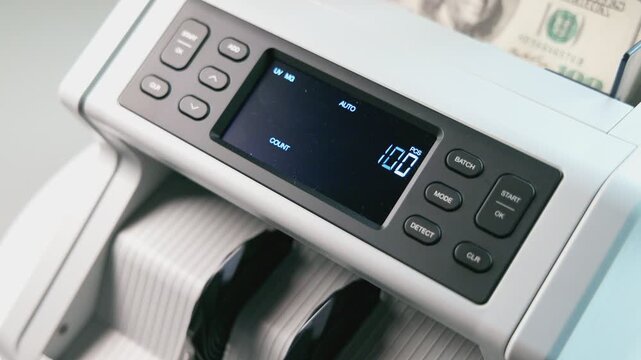 Modern Money Counter Rapidly Processes and Counts Stacks of Dollar Bills