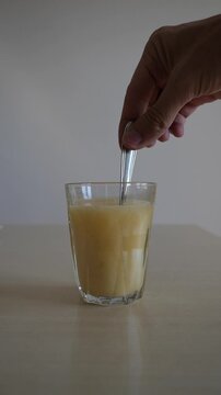 teaspoon mix the nutritional supplement powder into the glass of water. Slow motion vertical video