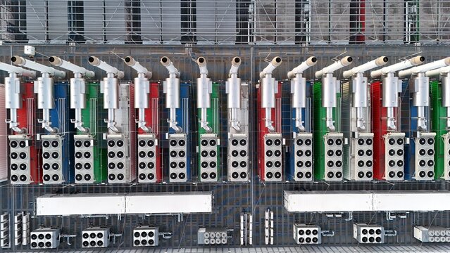 Aerial view of the Keppel Data Center Reit facility with rows of colorful industrial cooling units and ventilation systems in a grid pattern Offenbach am Main, Hessen, Germany.