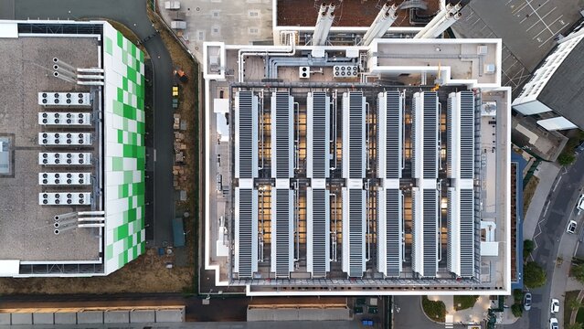 Aerial view of Keppel Data Center Reit featuring rows of cooling units and industrial infrastructure on the rooftop in Offenbach am Main, Hessen, Germany.