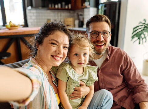 Happy family taking selfie together at home