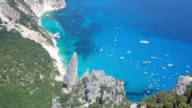 4k, stabilised, aerial and panoramic footage with full view of  world's number one cala goloritz&egrave; beach with its beautiful colours, spire Aguglia, Punta Caroddi, Baunei, Sardinia, Ogliastra, tourism, 