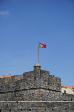 portugal flag over a medieval forteress 