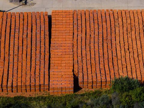 Aerial view of organized stacks of orange industrial bricks stored at the Patnow Power Station in Konin, Wielkopolskie, Poland.