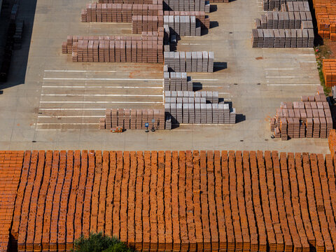 Aerial view of stacks of orange and grey bricks arranged in orderly rows on the concrete grounds of the ZE PAK S.A. Patnow Power Plant in Konin, Wojewodztwo wielkopolskie, Poland.