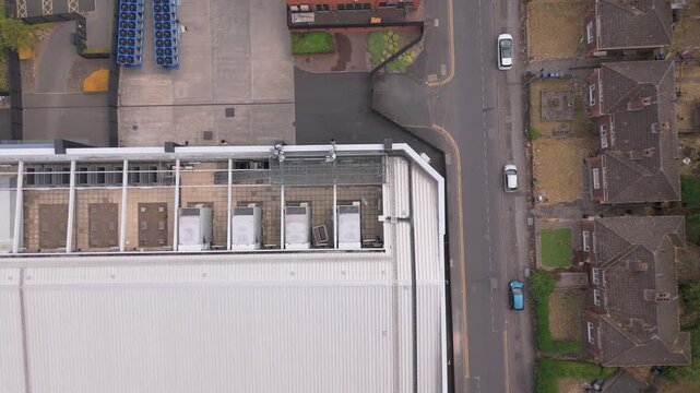A rising drone movement above the HVAC cooling system of a modern data centre.  It also has steel framework bays ready for future infrastructure expansion and scalability