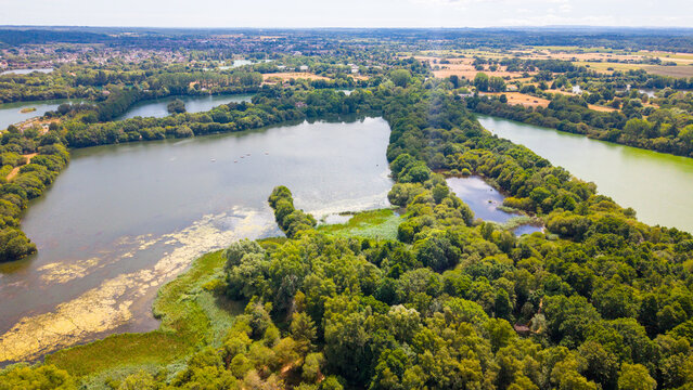 Aerial view of Bashford Lakes Nature Reserve featuring interconnected lakes, lush woodlands, and wetlands set within the scenic English countryside in Ringwood, Hampshire, United Kingdom.