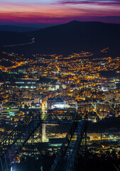 Fototapeta premium Night view of Mostar city lights and twilight sky from Fortica Skywalk glass bridge lookout, Bosnia and Herzegovina