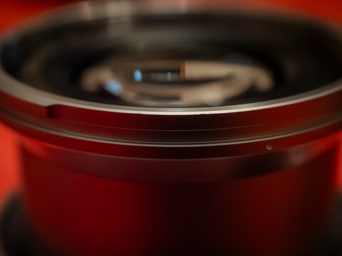 Macro close up of a camera lens metallic barrel ring and internal glass elements showcasing precision photographic equipment