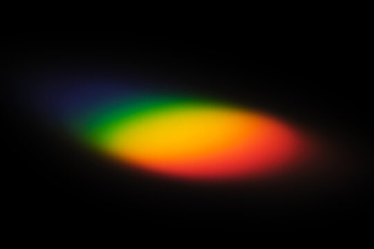 Abstract rainbow light refraction on black background