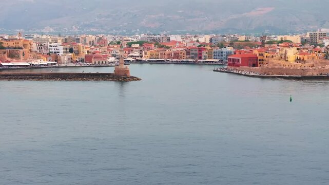  View of Chania with the amazing lighthouse, mosque, venetian shipyards, Crete, Greece.Waves crashing on lighthouse, Beautiful Greece and best scenic places - panorama