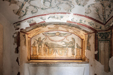 A vibrant painted mural featuring a mummified figure inside the Tigrane Tomb, a 2nd-century CE Roman-era burial chamber at the Catacombs of Kom el Shoqafa in Alexandria Egypt. © Kirk Fisher
