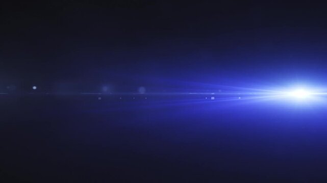 Cinematic anamorphic blue optical lens flare light leak moving horizontally across a dark background for video overlay and motion transition effects.