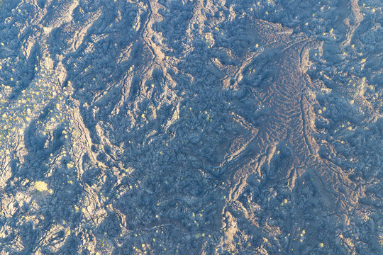 A bird's eye view of an ancient lava field shows an extremely rugged and inhospitable landscape near Bend, Oregon. This vast area is part of the volcanic Cascade Mountain Range.
