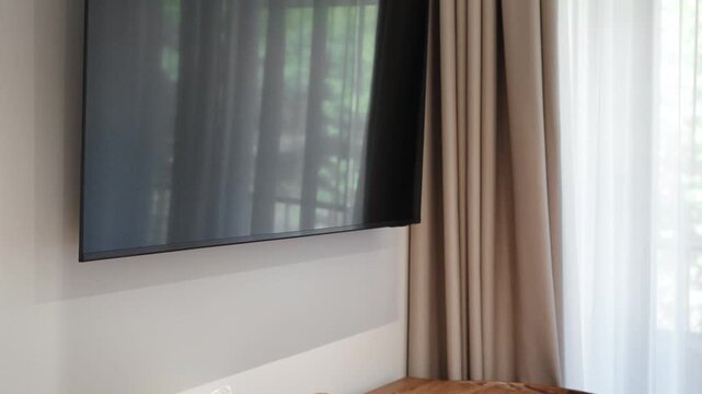 large plasma TV above the dining table in a modern apartment