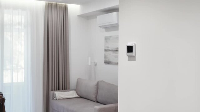 white thermostat for underfloor heating and climate control systems. control panel. apartment, house, hotel. smart home. automatic heating system. technology. stylish designer expensive repair